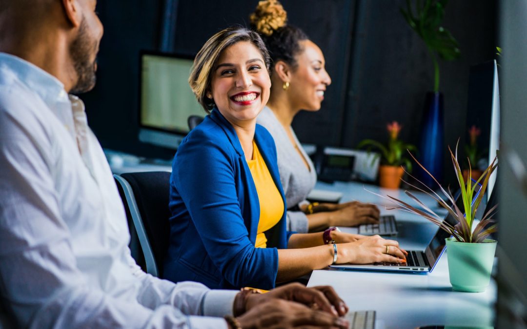 Female business professional working in an professional setting on a laptop.