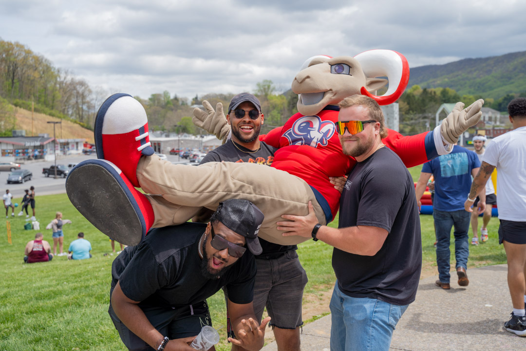 A group of students lift Victor E. Ram