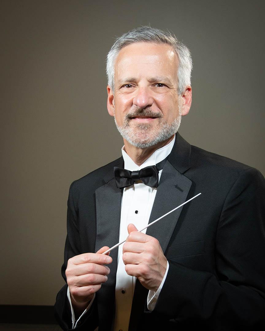 Former BU music professor Bryant Moxley holds a conducting baton.