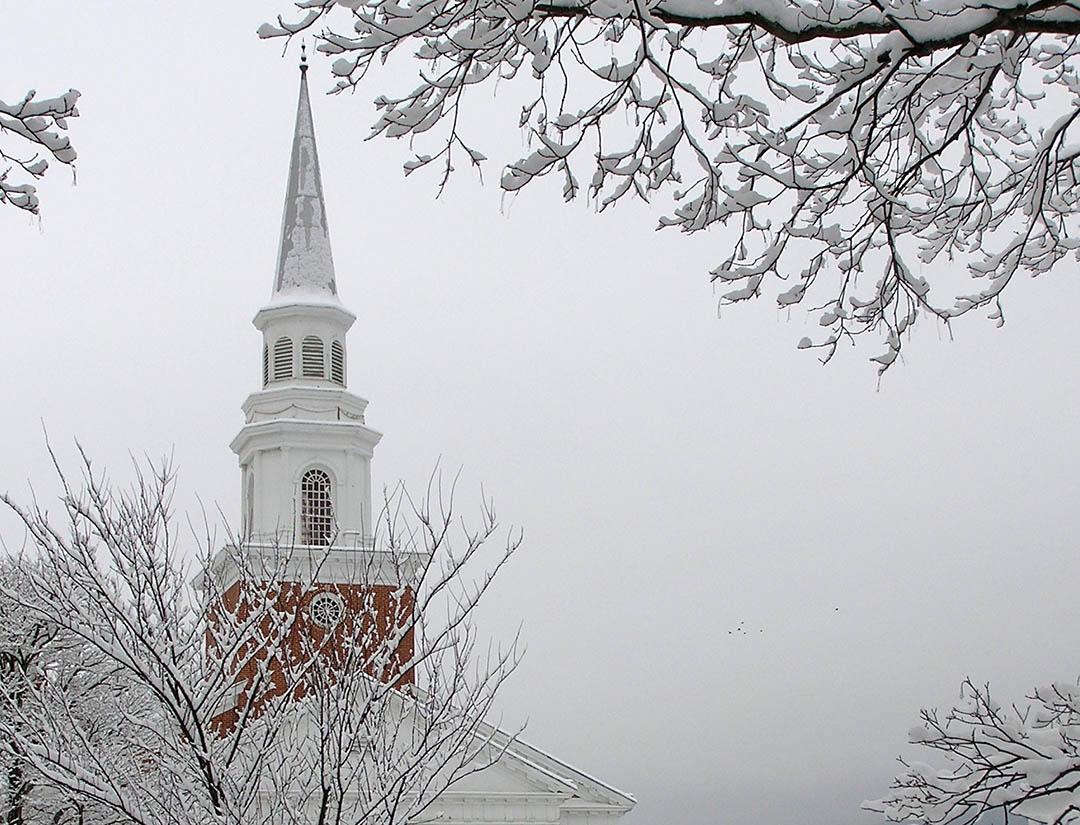 A steeple on a snowy day.
