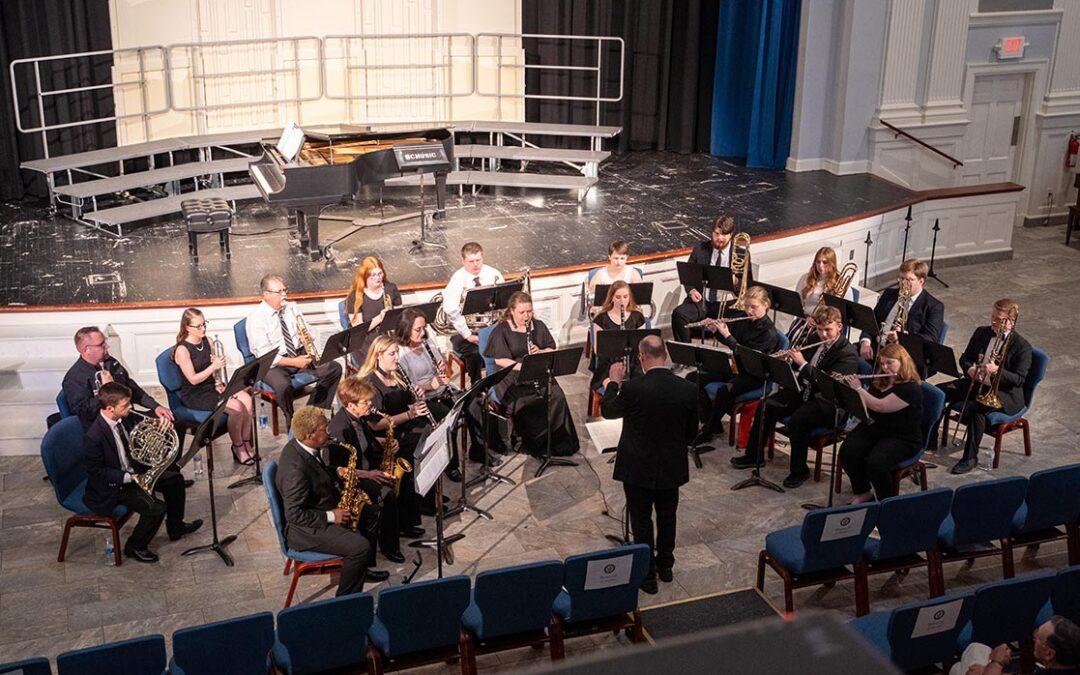 A concert band performing in a chapel.