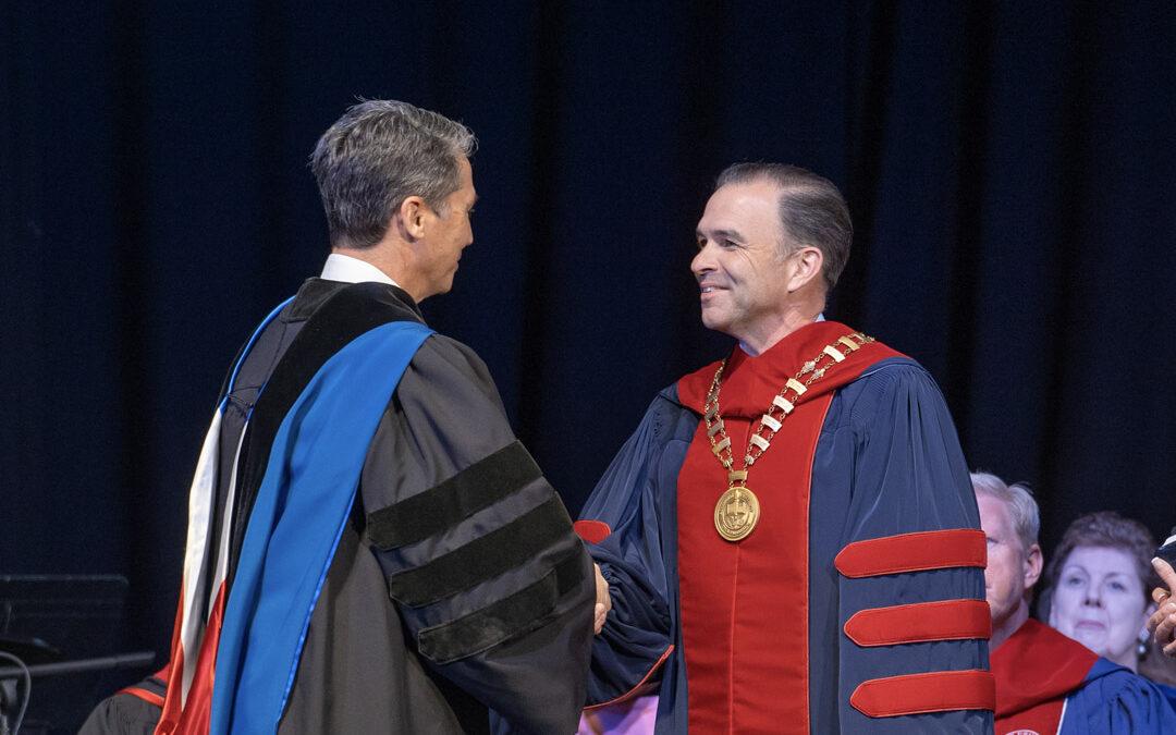 Dr. Peterson and Dr. Olive shake hands.