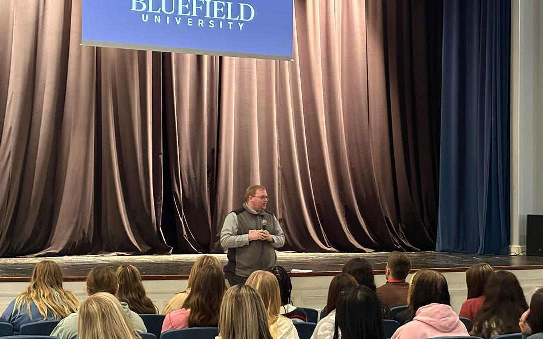 An admissions counselor speaks to students