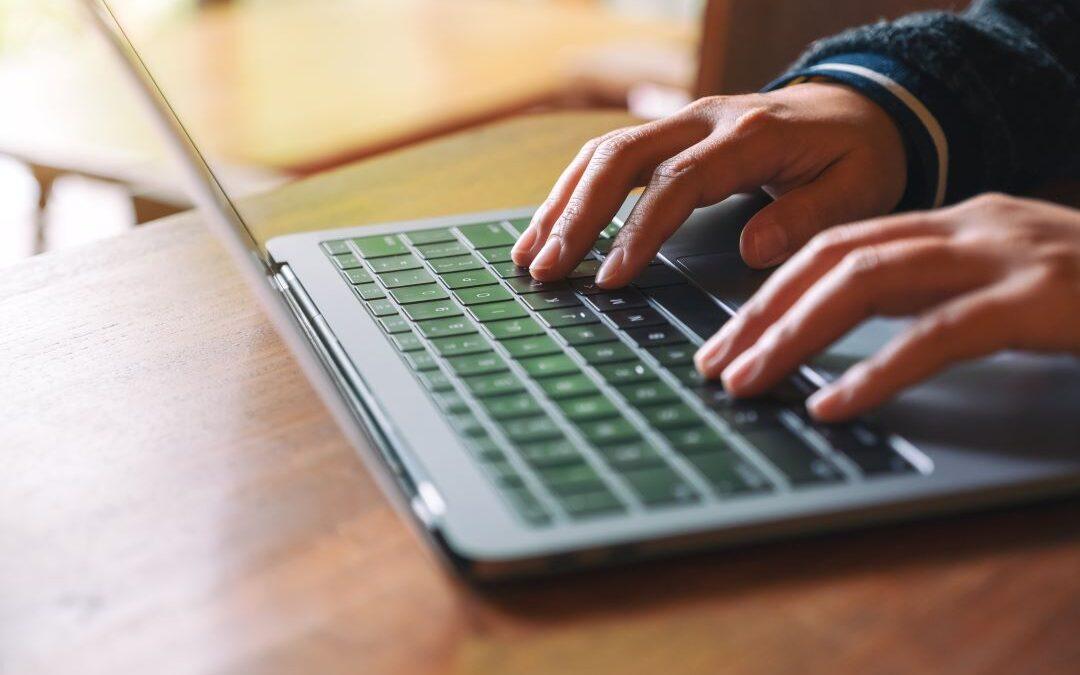 A person typing on a laptop.
