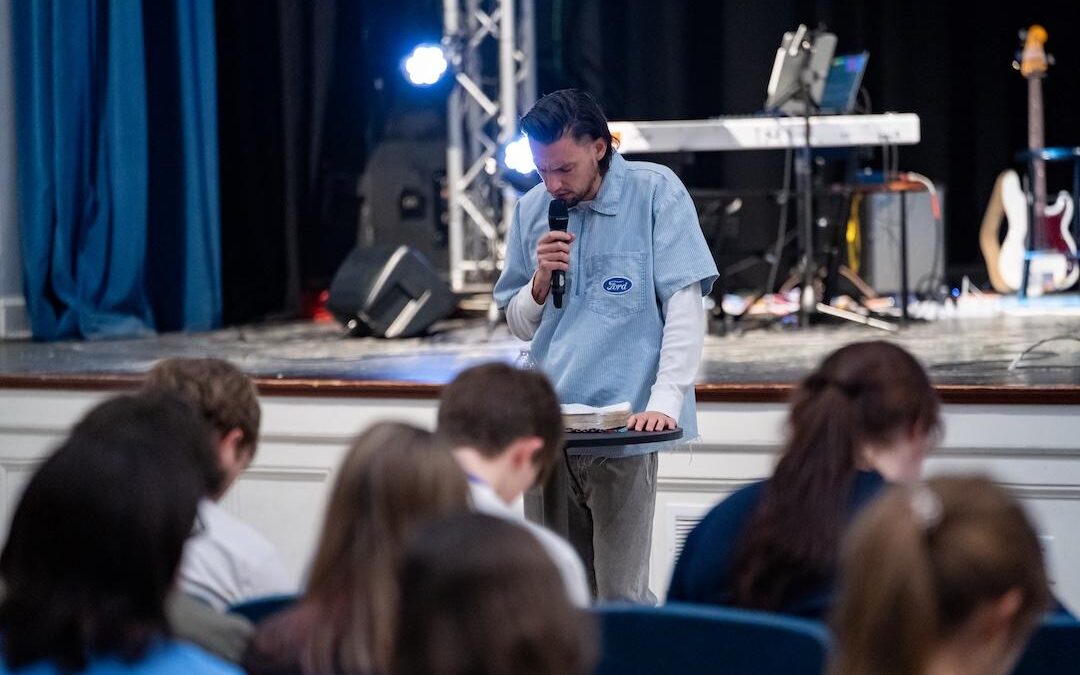 Aaron Smith leads prayer at a previous Revival Night.