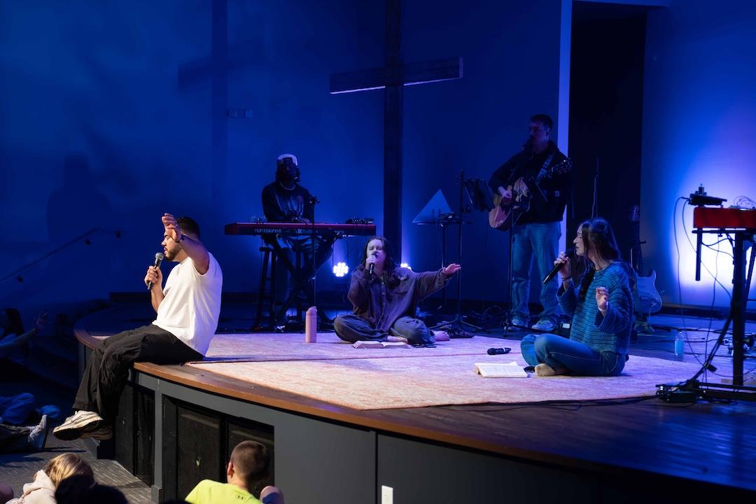 Students leading worship at a conference.