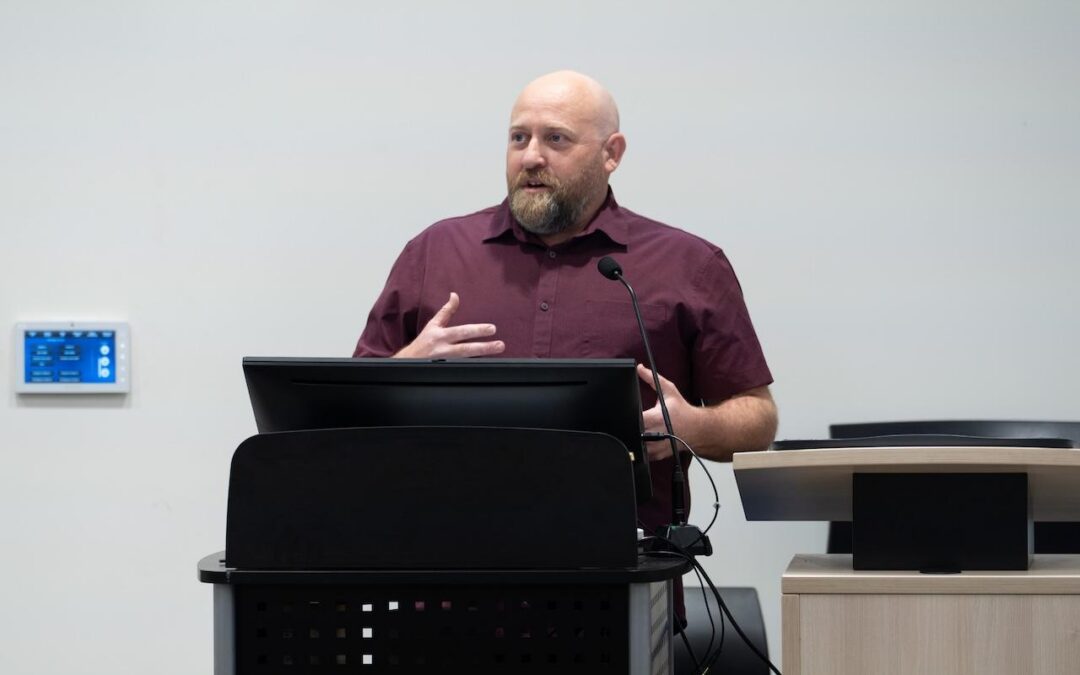 A picture of Dr. Michael Takacs speaking.