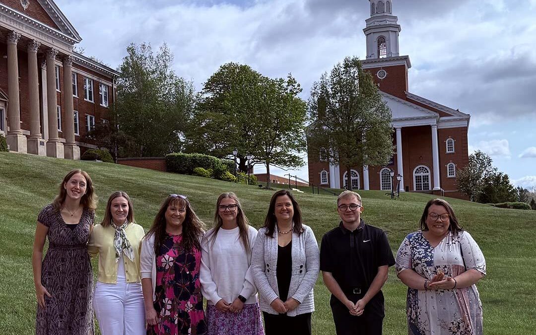 Seven education students stand in front of Harman Chapel.