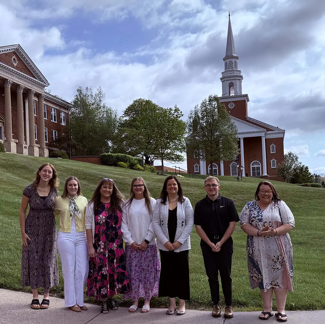 Seven education students stand in front of Harman Chapel.