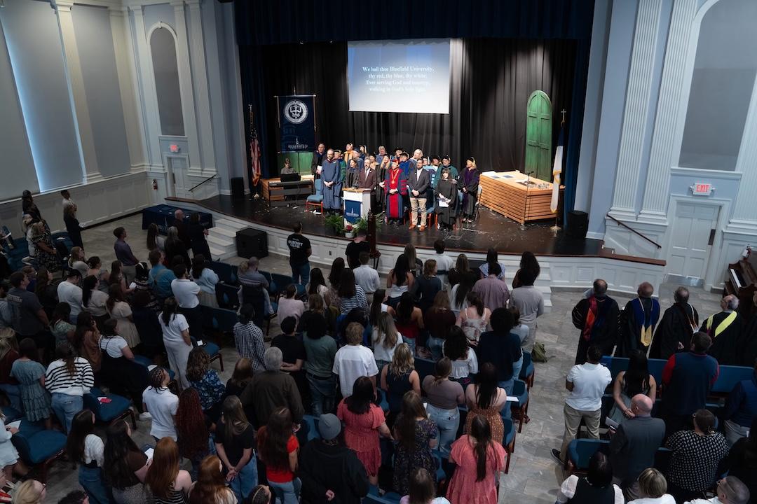 Dr. Yowell leads the congregation in a song in the chapel.