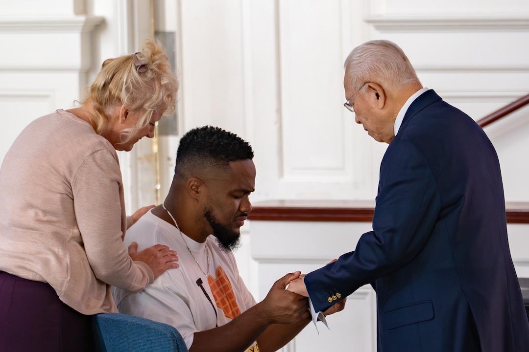 Mary Duremdes and Dr. Generoso Duremdes pray over the 2025 Duremdes Christian Emphasis Speaker, Markus McFolling.
