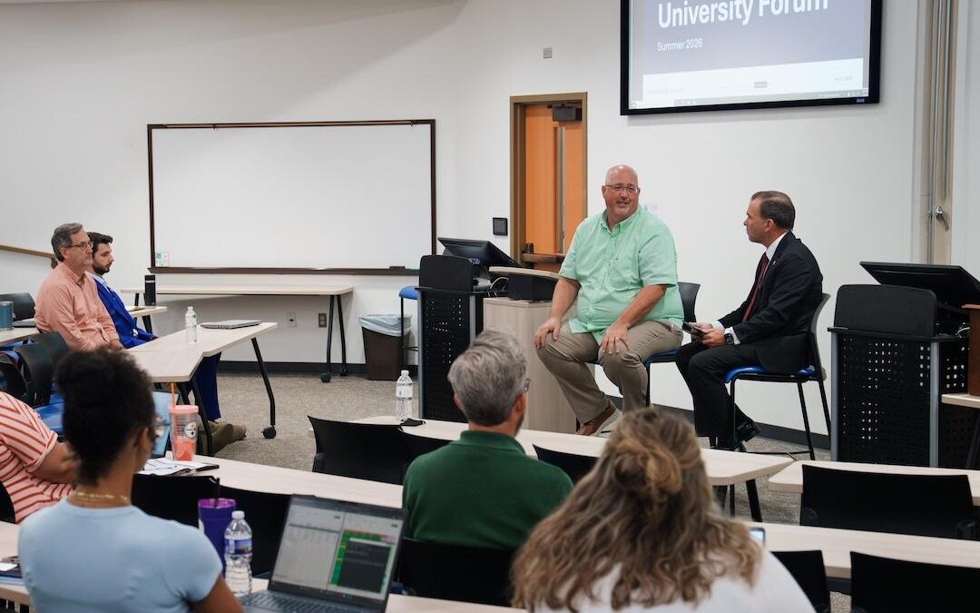 Dr. Craig and Dr. Peterson address faculty and staff.